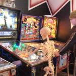 Photo by Kira Erickson/Whidbey News-Times
Tim Leonard plays a round of pinball with a skeletal friend in the Machine Shop.