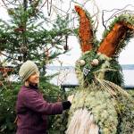 Tobey Nelson, a floral designer who brought Juniper B. Bunny to life, makes adjustments to her creation on Thursday. The big green rabbit is part of an eco-friendly, holiday-themed installation in Langley. Juniper can be found next to his Christmas tree at Boy and Dog Park on First Street. Photo by Kira Erickson/South Whidbey Record