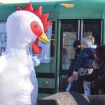 The Whidbey Island Chicken meets young fan, Aria Smith, and her dad, Josiah, on Saturday morning in Oak Harbor. Emily Gilbert/Whidbey News-Times