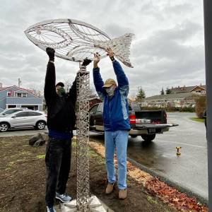 Artist Wayne Kangas, left, and Langley Arts Fund member Don Wodjenski install the Village by the Seas newest public art feature, a weather vane. Photo provided
