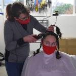 Naomie Welshans shaves Cheryl Lueders head in a show of support for Annie Cash. Photo by Emily Gilbert/Whidbey News-Times