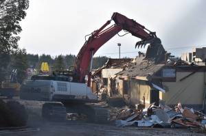 Photo by Emily Gilbert/Whidbey News-Times An excavator demolishes the Oak Harbor McDonalds on Feb. 17. The madrona tree on the left side will be taken down to make way for the new building, although one woman tried to save it.