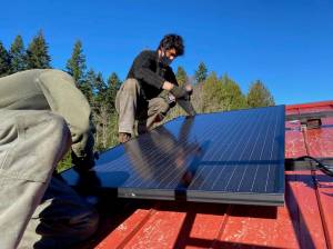 Adam Wundrow of Whidbey Sun and Wind installs a solar panel.