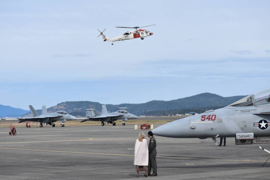First Lady Dr. Jill Biden and Lt. Cate Oakley watch a helicopter after a tour of an aircraft hangar at NAS Whidbey March 9, 2021. Photo by Emily Gilbert/Whidbey News-Times