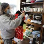Photo by Kira Erickson/South Whidbey Record
Cindy Buchanan, founder of Whidbey Island Angels, hangs up a toddler's Minnie Mouse outfit.