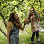 Aja Stewart and her daughter Rainey, 4, search for bees in a tree in bloom at Sweetwater Farm in Clinton. (Photos by Kira Erickson/South Whidbey Record)