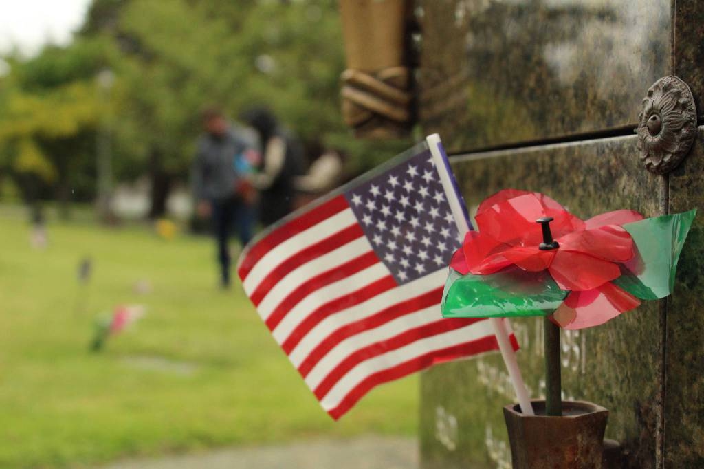 Exceptional Academy students decorated veterans graves with American flags and homemade poppies.