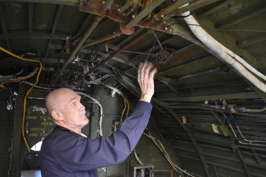Pacific Northwest Naval Air Museum President Wil Shellenberger shows the inside of the PBY-5A Catalina aircraft. He said the museum is looking for volunteer docents to give tours of the plane this summer. Photo by Emily Gilbert/Whidbey News-Times