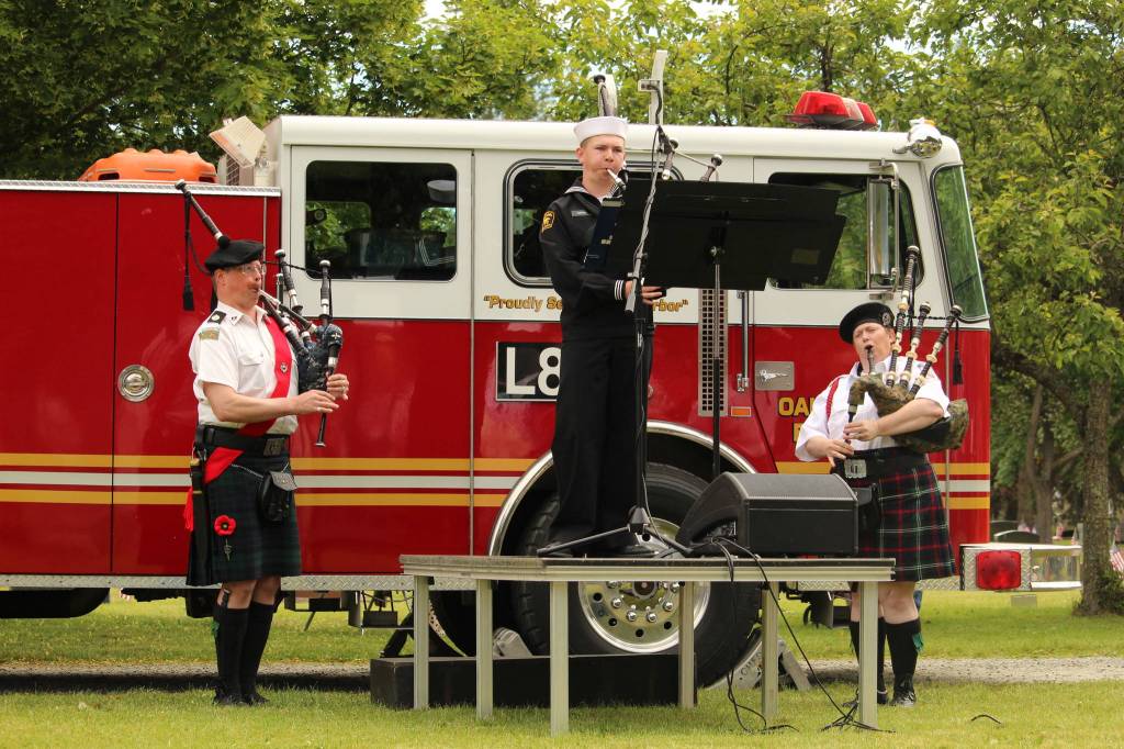 AR Johnathan Ferrell, center, plays Amazing Grace, accompanied by Don Scobie and Shannon Mowatt.