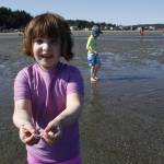 While enjoying the sunny weather Wednesday at the public beach at Double Bluff in Freeland, Grey Fortney, 7, shows off a jellyfish she collected to release back into the water. (Photos by Kira Erickson/South Whidbey Record)