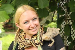 Amanda Ferrara poses with ball python Lemon and bearded dragon Drogon. (Photo by Karina Andrew/Whidbey News-Times)
