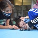 Photo by Emily Gilbert/Whidbey News Group
Fourth-graders Aura Smith and Matias Glass adjust some of the parts on Smiths solar car before testing it. The students learned about sources of alternative energy in Jean Cravys South Whidbey Elementary school class this year.