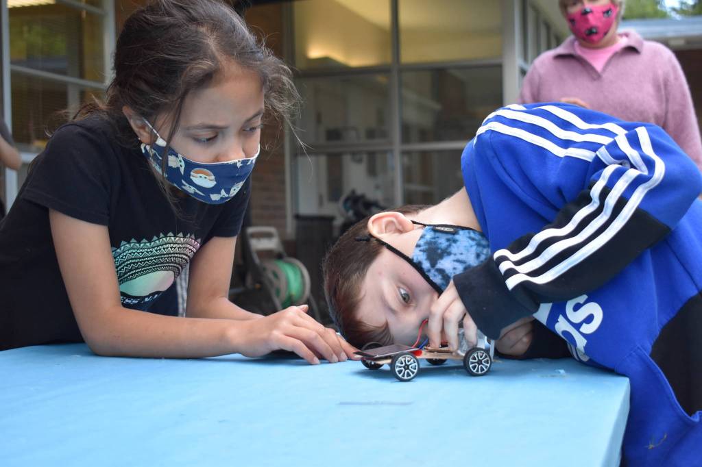 Photo by Emily Gilbert/Whidbey News Group
Fourth-graders Aura Smith and Matias Glass adjust some of the parts on Smiths solar car before testing it. The students learned about sources of alternative energy in Jean Cravys South Whidbey Elementary school class this year.