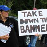 Maureen Greene displays a sign and distributes informational papers opposing the Black Lives Matter banner. (Photo by Karina Andrew/Whidbey News-Times)