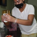Taylor Moore drizzles honey over one of her smoothie bowls. (Photo by Karina Andrew/Whidbey News-Times)