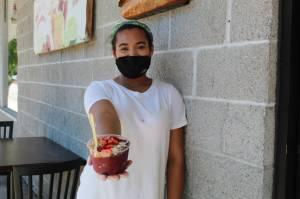 Taylor Moore shows off one of her signature smoothie bowls. (Photo by Karina Andrew/Whidbey News-Times)