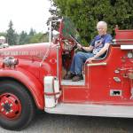 Gary Gabelein, this years grand marshal of the Whidbey Island Fair parade, sits atop his 1951 fire engine. (Photo by Kira Erickson/Whidbey News-Times)