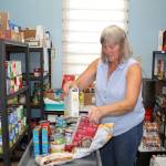 North Whidbey Help House executive director Jean Wieman prepares a food kit for a family of four. (Photo by Karina Andrew/Whidbey News-Times)