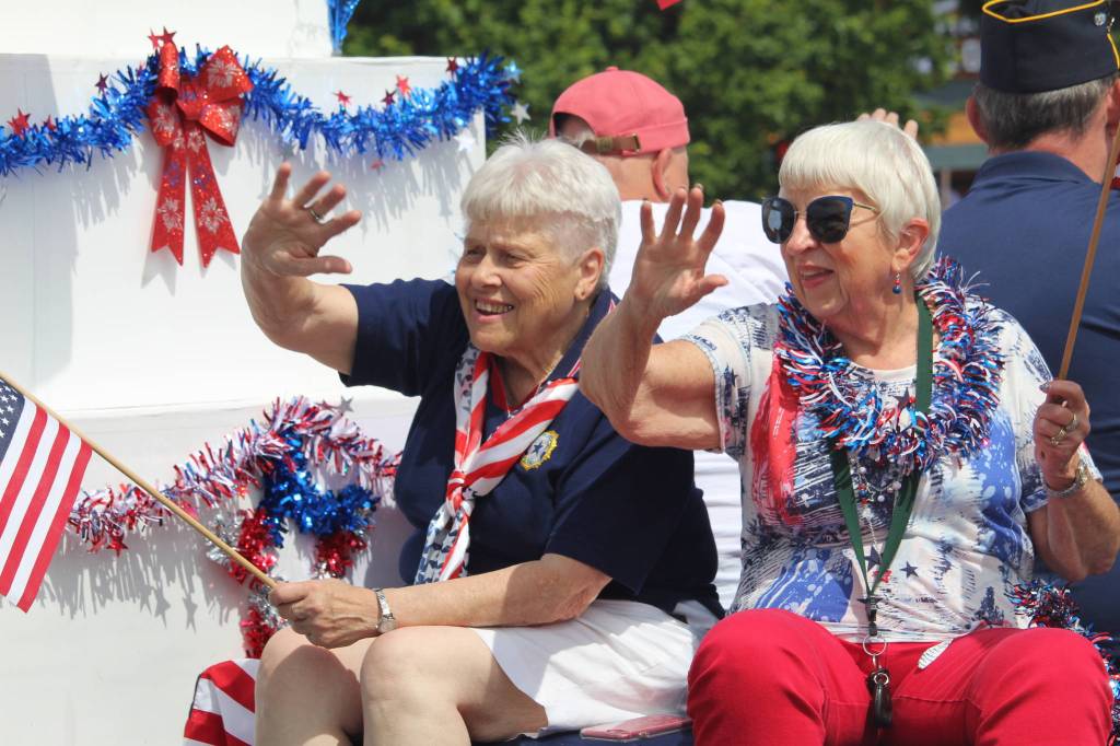 Two women wave at the crowd. (Photo by Karina Andrew/Whidbey News-Times)