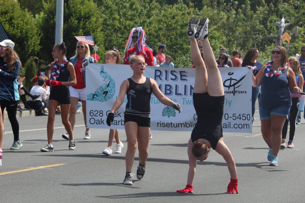 A gymnast walks on her hands in the parade. (Photo by Karina Andrew/Whidbey News-Times)