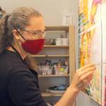 Becca Heavrin paints in her studio. (Photo by Karina Andrew/Whidbey News-Times)