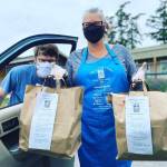 Coupeville Farm to School school garden coordinator Zvi Bar-Chaim, left, and Julieanna Purdue, member of Cook for a Cause Planning Committee and farmer, deliver curbside pick-up meals at last years Cook for a Cause fundraiser. (Photo provided)