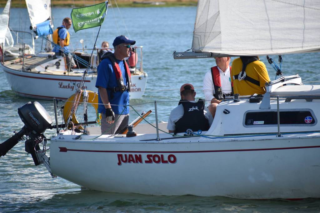 Photo by Emily Gilbert/Whidbey News-Times 
Dave Steckman talks to his crew aboard the <em>Juan Solo </em>during the Oak Harbor Yacht Clubs Thursday night race last week. Steckman said hes looking forward to the clubs new regatta, the Whidbey Summer Classic, this weekend.
