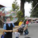 Bubble Guy Matt Henry blows a big bubble for children to chase at the Whidbey Island Fair Thursday. The performer is a regular fixture at the fair, which runs through Sunday. (Photo by Kira Erickson/South Whidbey Record)