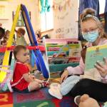 Little Oaks Preschool teacher Ashley Kulka reads to the toddler class. (Karina Andrew/Whidbey News-Times)