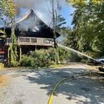 Firefighters respond to a structure fire on Woodbine Road Monday. (Photo courtesy of South Whidbey Fire/EMS)