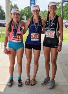 Kaia Swegler Richmond, center, shows off her gold alongside second-place finisher Corinn Brewer, right, and third-place finisher McKenzi Popper. (Photo provided by Karen Swegler)