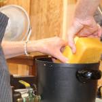 Photo by Karina Andrew/Whidbey News-Times
Priscilla Lowry melts beeswax to filter through a cheese cloth and pour into candles.