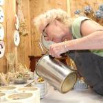 Priscilla Lowry pours beeswax candles in different shapes and patterns. This year is her first time exhibiting at the Coupeville Arts and Crafts Festival. (Photo by Karina Andrew/Whidbey News-Times)