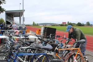 Lions Club member Gary Parker locks up bikes to be sold at the garage sale this weekend. (Photo by Karina Andrew/Whidbey News-Times)