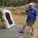 Burt Beusch, executive director of the Cloudstone Foundation, points out one of many sculptures in the Cloudstone Sculpture Park. (Photo by Kira Erickson/South Whidbey Record)