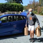 Andrew Curtis drops off groceries at a home in Clinton on a delivery run for Whidbey Deliveries. (Photo by Karina Andrew/Whidbey News-Times)