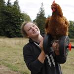 Photo by Kira Erickson/South Whidbey Record
Sarah Santosa lifts a chicken and a weight.