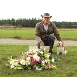 Photo by Karina Andrew/Whidbey News-Times
Don Meehan and his dog, Cooper, kneel beside a grave Meehan found using Find a Graves GPS database.
