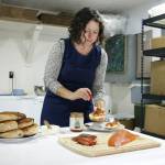 Photo by Kira Erickson/South Whidbey Record
Emily Wilder, owner of Salinity Seafood & More, adds kimchi to a bagel decked out in creamy spreadable cheese and smoked salmon.