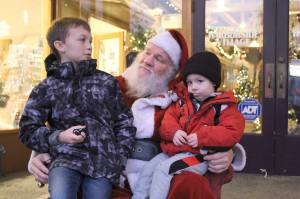Photo by Karina Andrew/Whidbey News-Times
August Stohmire, 2, and his young uncle Ryan Brown, 9, meet Santa Claus Dec. 4. on Pioneer Way.