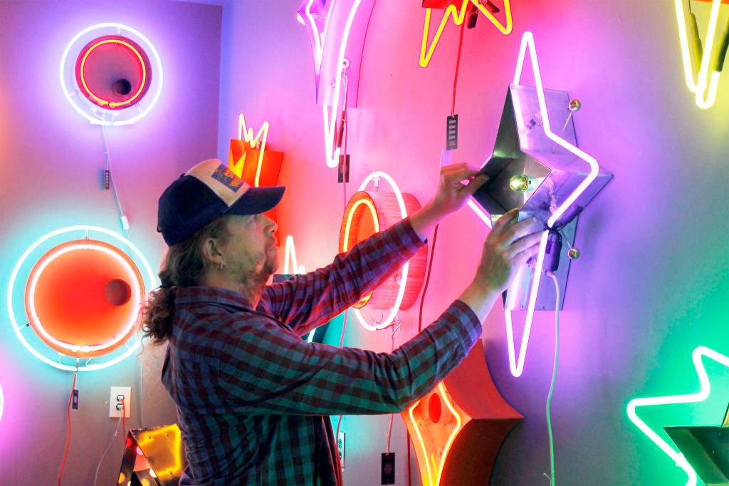 File photo by Kira Erickson/South Whidbey Record
Tim Leonard, owner of the Machine Shop in Langley, hung a purple neon star he made on the wall of his arcade, which reopened in 2021.
