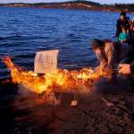 Photo by David Welton
Michael Clyburn sets afloat a blazing Viking-style ship he built to honor the late Peter Hansen. On the second anniversary of Hansens passing, friends and family members gathered to remember the colorful South Whidbey resident.