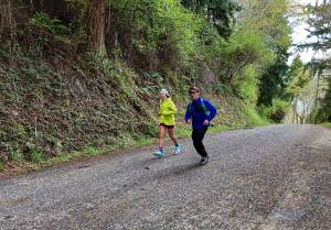Riley Nachtrieb, left, runs the last mile of the Whidbey Island Traverse accompanied by Herman Meyer. (Photo provided)