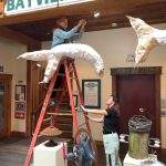 Photo provided
Melissa Koch hangs one of her ghost salmon in the Bayview Cash Store. The installation is made of upcycled fabric, plastic, cane and wax.