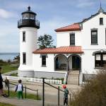 A group of children take a look at the restored Admiralty Head Lighthouse Thursday, April 7, 2022, near Coupeville, Washington. (Ryan Berry / The Herald)