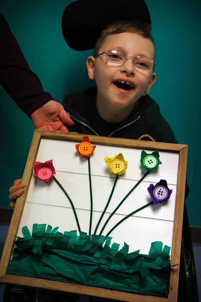 Photo by David Welton
Kieren Bearlin shows off the artwork he made for the art show.