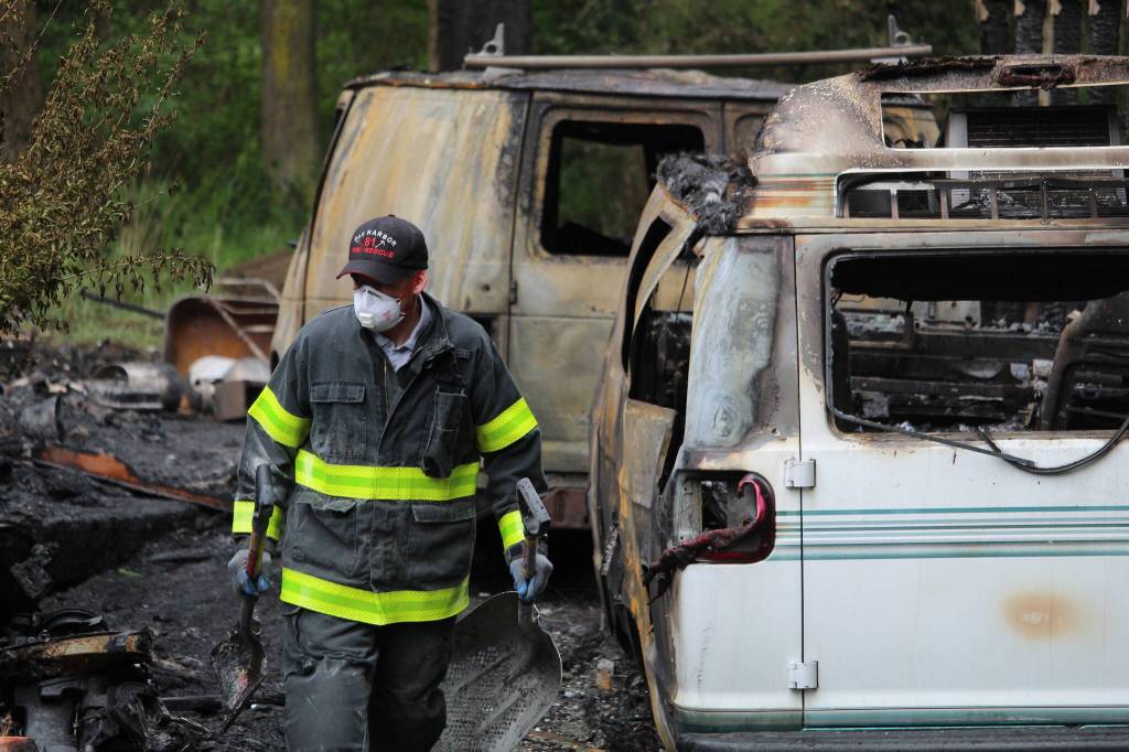 Firefighters investigate at the scene of a North Whidbey residential fire Thursday morning. (Photo by Karina Andrew/Whidbey News-Times)
