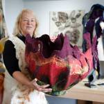 Fiber artist Janet King holds an enormous felt creation she refers to as a vessel. King is one of the participating artists on the Whidbey Art Trail this year. (Photo by David Welton)