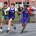Photos by John Fisken
Sophomore Michael Johnson-Howard, right, passes the baton to junior Barrett Schmall during the 4 x 100 meter relay. The relay team took second place with a time of 45.37 seconds.