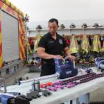 Photo by Karina Andrew/Whidbey News-Times
<em>Firefighter Kevin Frondozo demonstrates the use of a battery-operated ram tool, one of five extrication tools recently purchased for the Oak Harbor Fire Department using American Rescue Plan Act funds.</em>